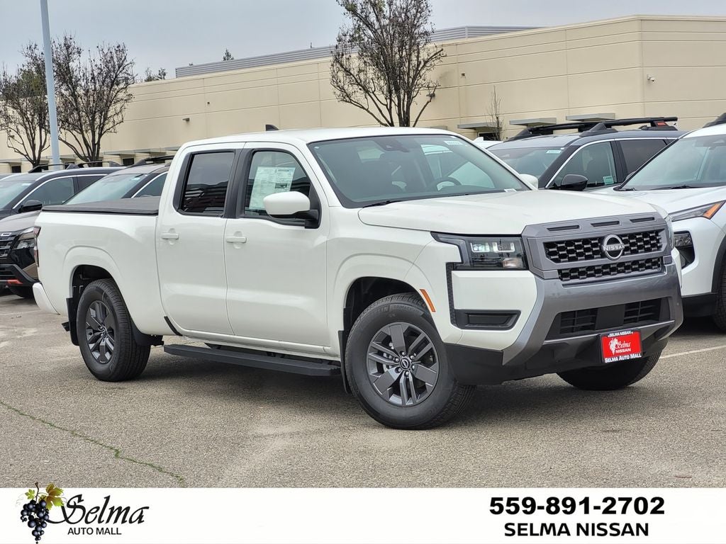2026 Nissan Frontier Crew Cab SV Long Bed in Glacier White — front three-quarter view